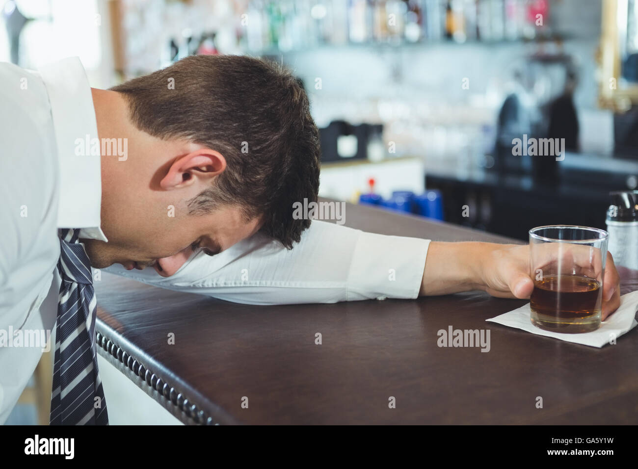 Drunken man sleeping on a bar counter Stock Photo Alamy