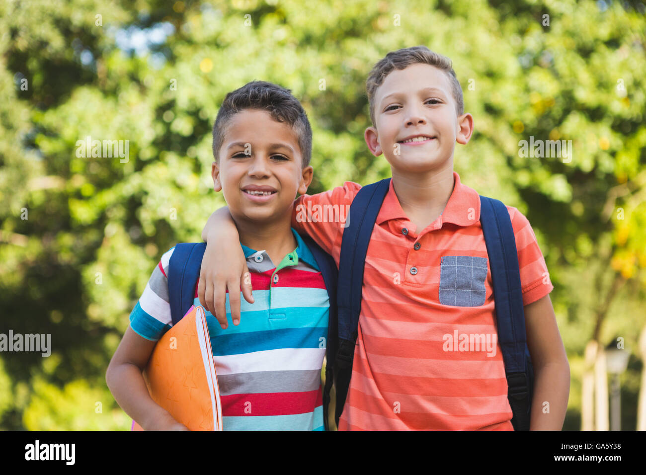 Smiling schoolkids standing in campus Stock Photo