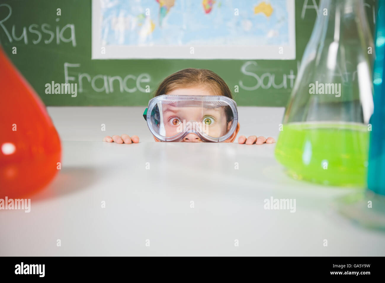 Schoolgirl doing a chemical experiment in laboratory Stock Photo