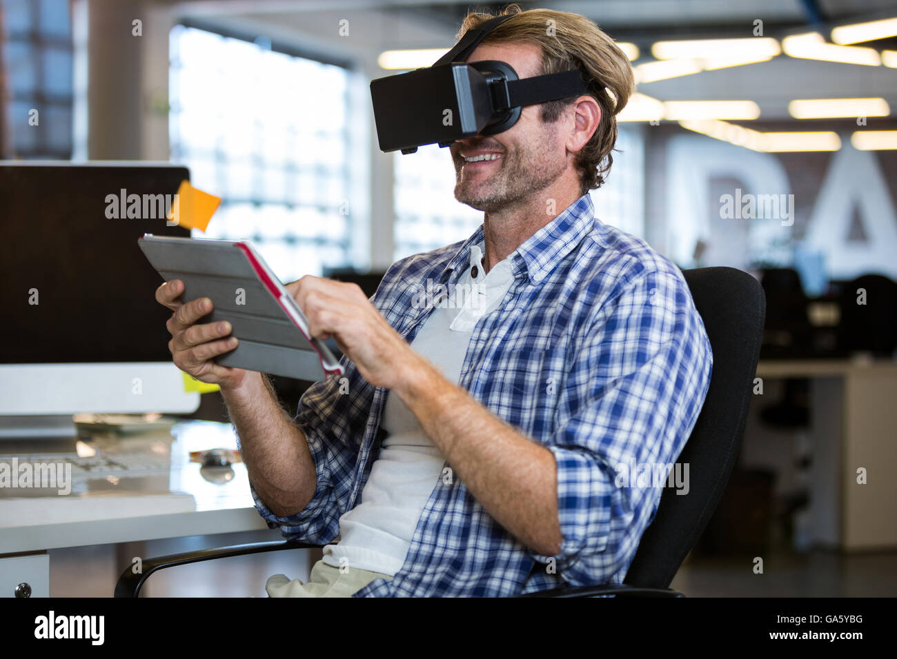 Happy businessman using virtual reality simulator Stock Photo - Alamy