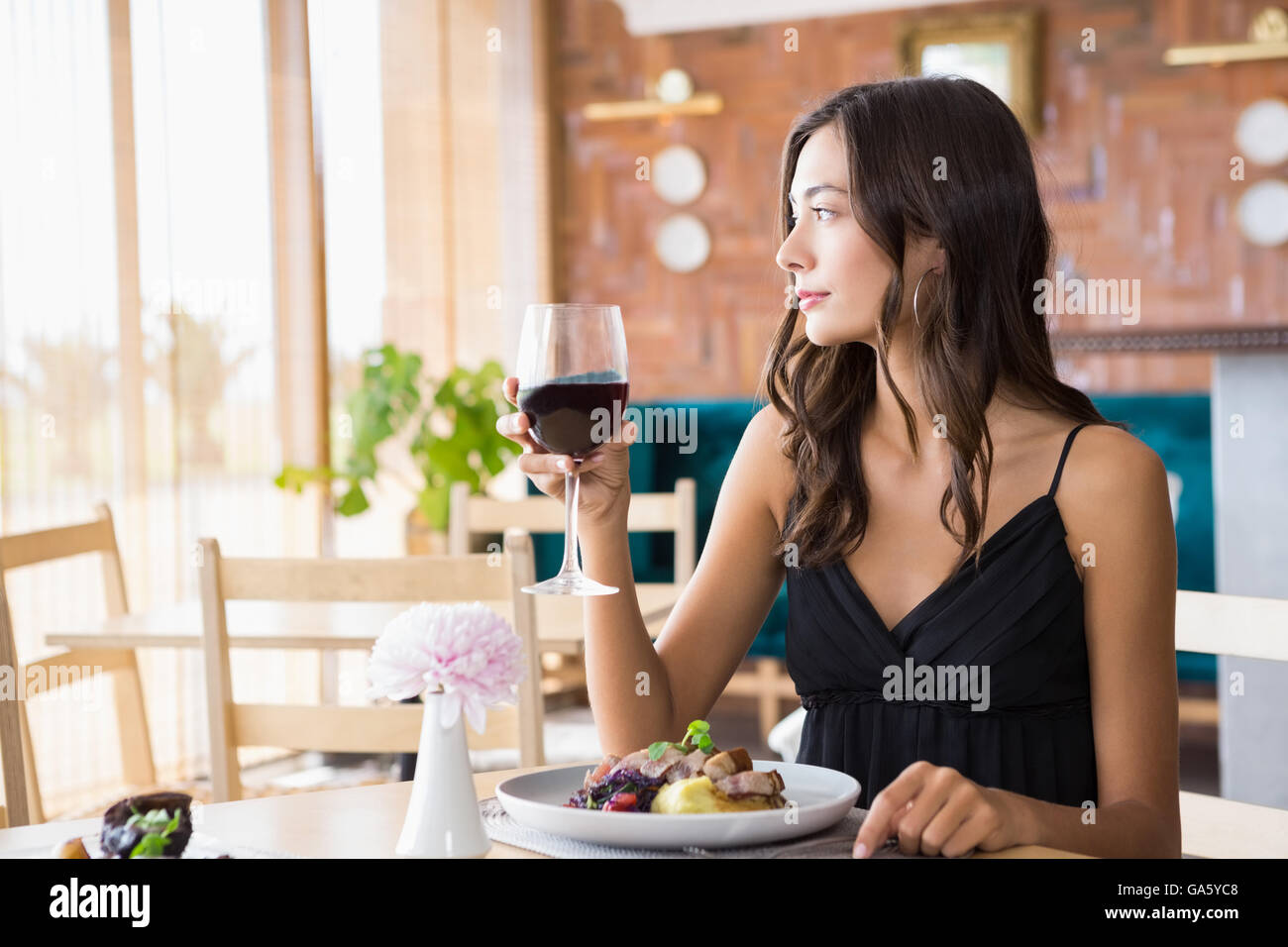 Beautiful woman having wine with meal Stock Photo