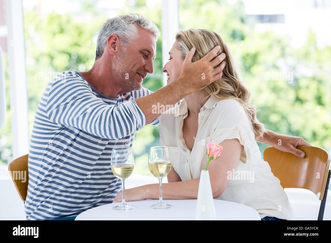 Romantic couple sitting at restaurant Stock Photo