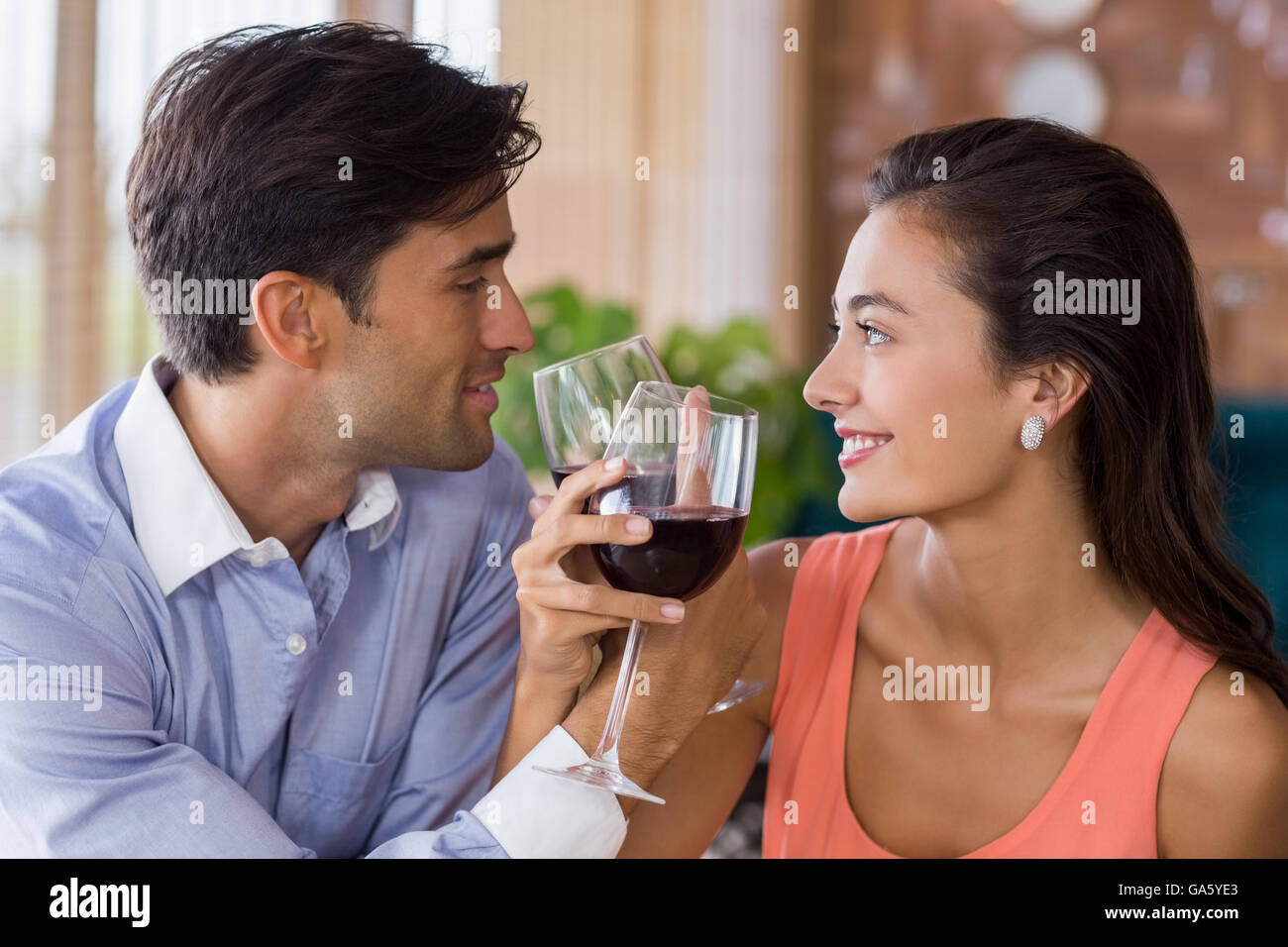 Couple toasting with arms crossed with a glass of wine Stock Photo Alamy