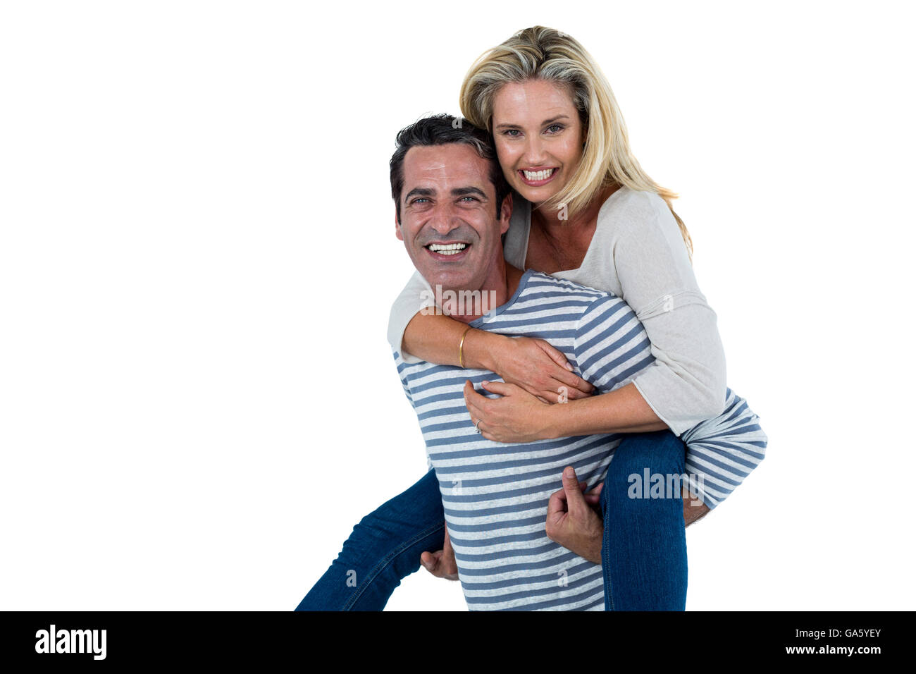 Mid adult man carrying woman piggyback Stock Photo