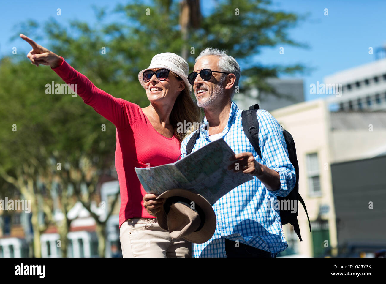 Woman pointing while standing by man in city Stock Photo