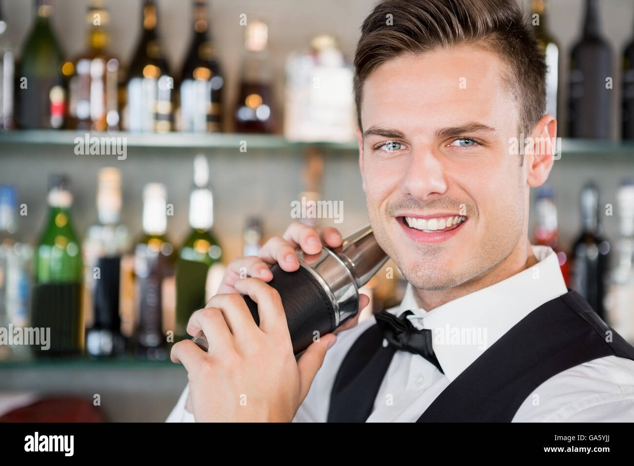 Waiter shaking cocktail Stock Photo Alamy