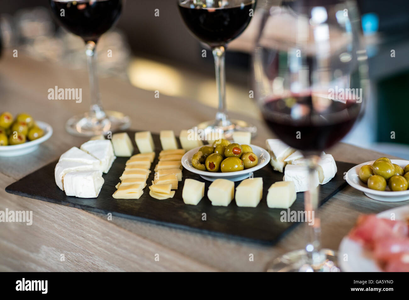 Wine and food arranged on table Stock Photo