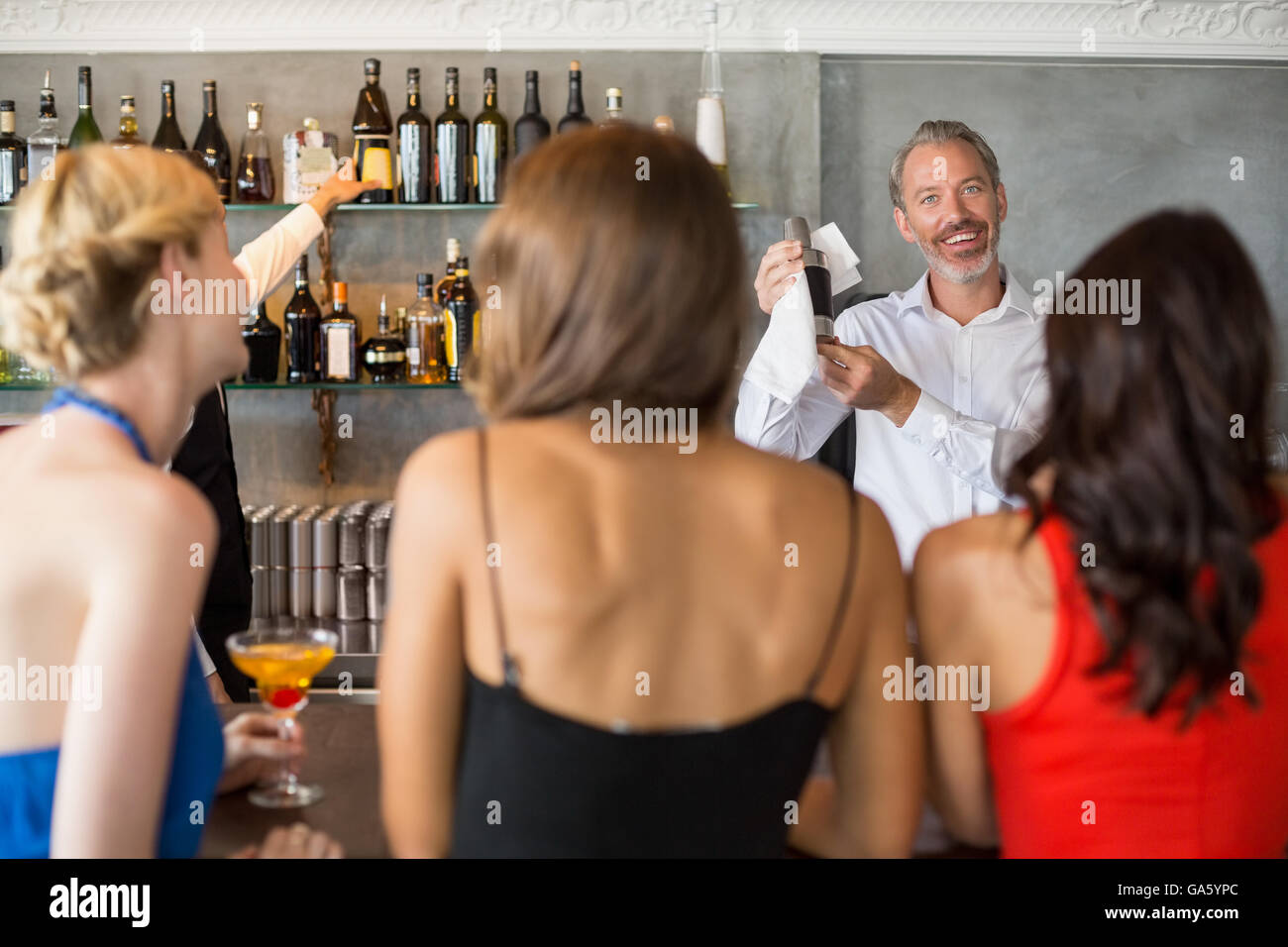 Female friends ordering drinks Stock Photo