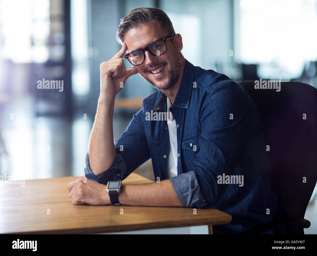 Portrait of man sitting in office Stock Photo