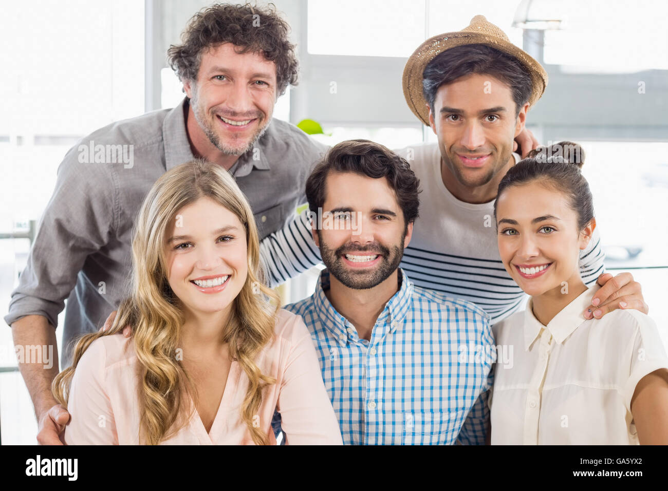 Portrait of smiling friends posing together Stock Photo