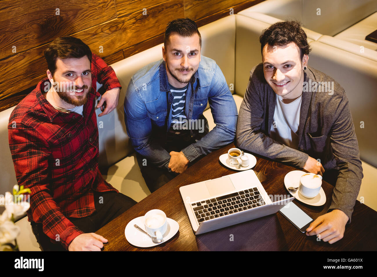 High angle portrait of male friends with laptop Stock Photo