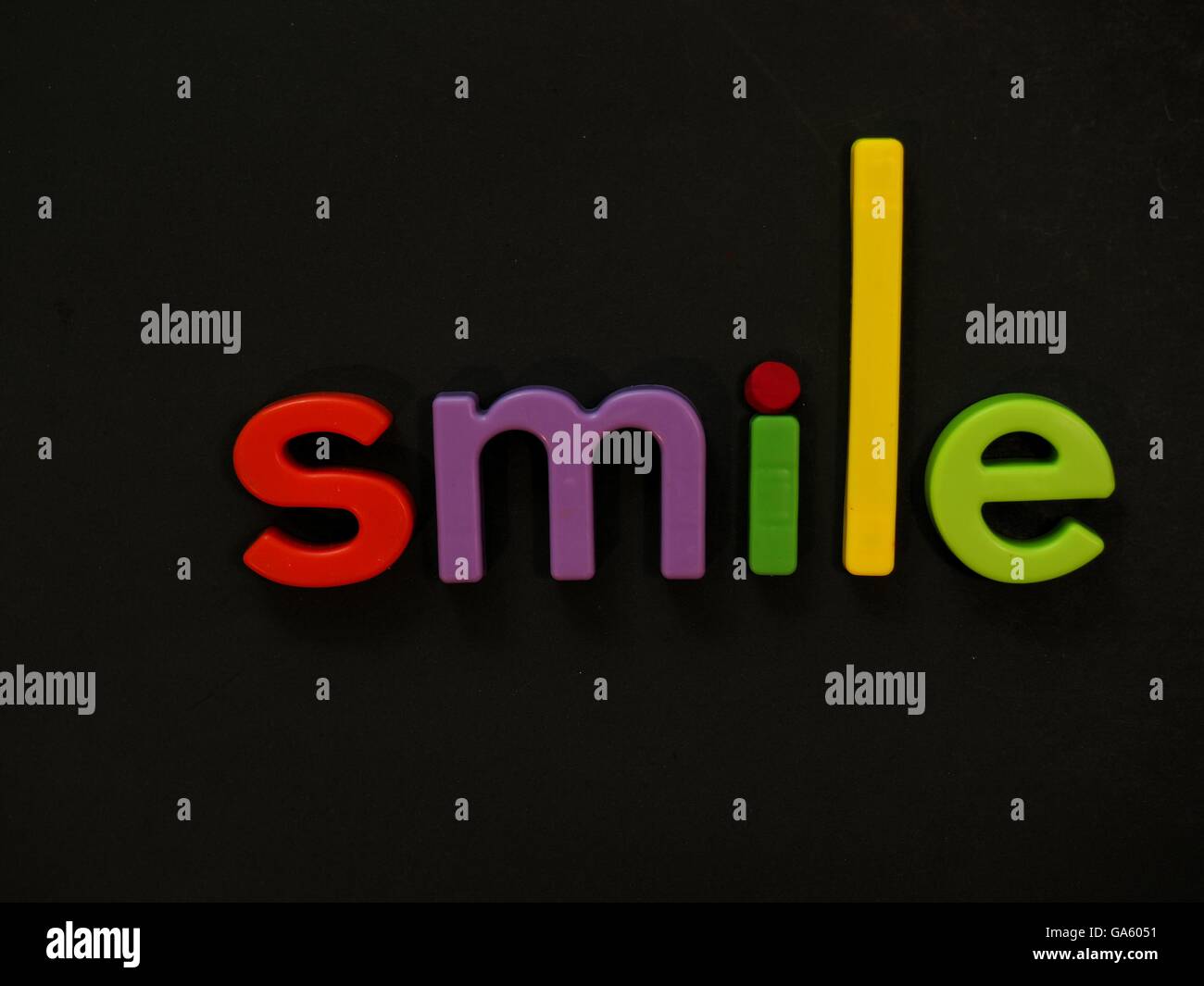 Smile! Inspirational message in vibrant colorful magnet letters Stock Photo