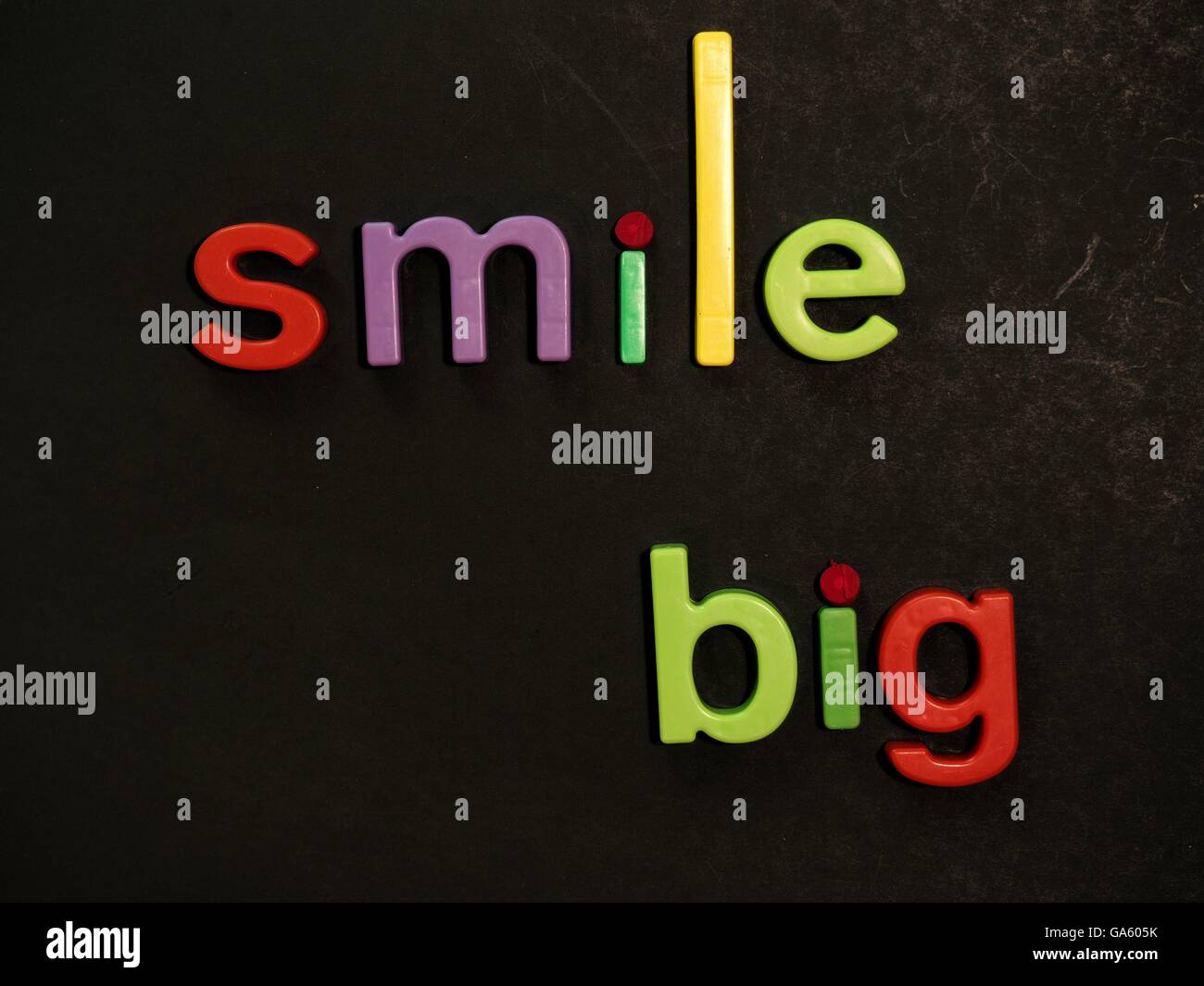 Smile! Inspirational message in vibrant colorful magnet letters Stock Photo
