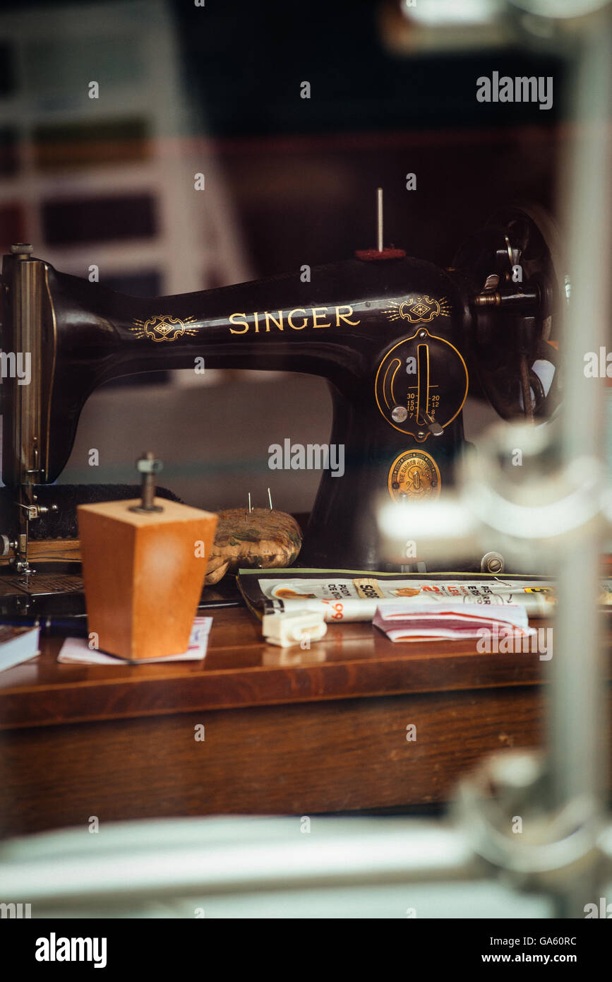 Singer sewing machine behind the glass of atelier Stock Photo