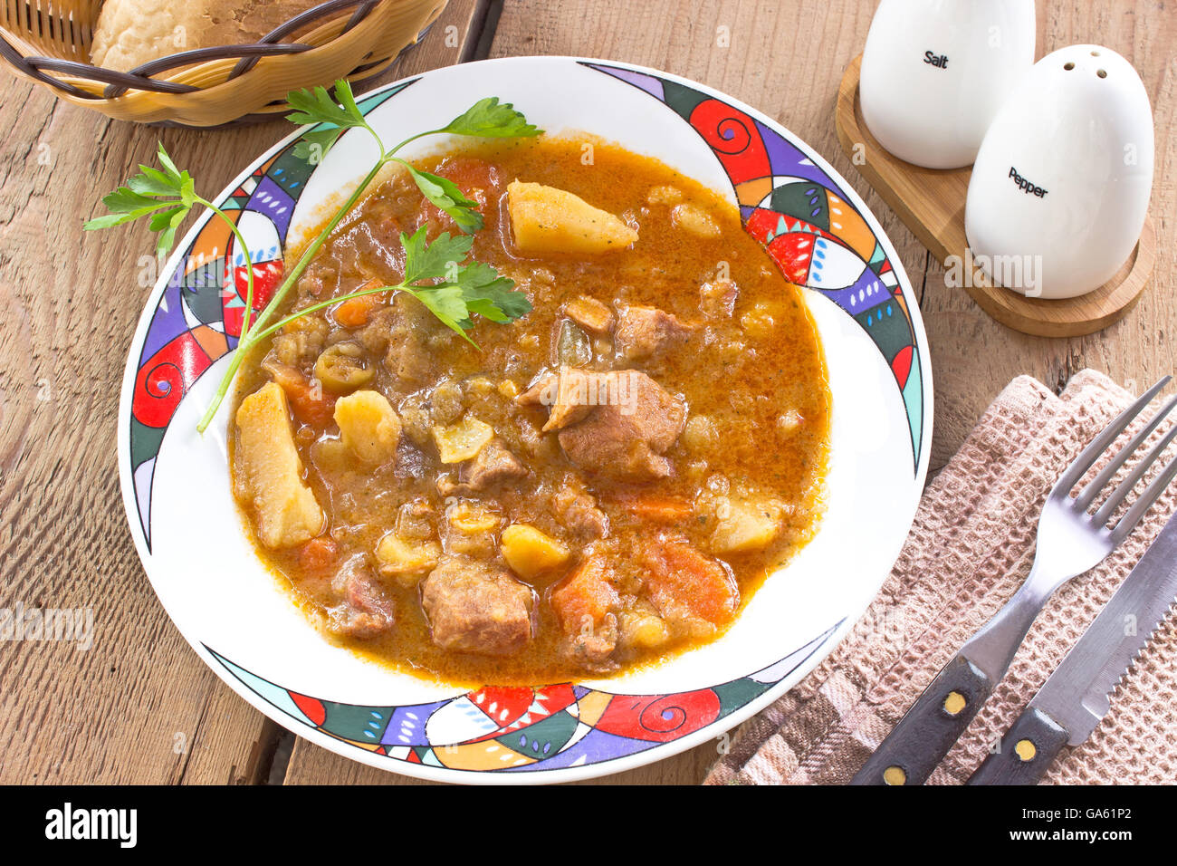 Pork stew in plate on wooden table Stock Photo