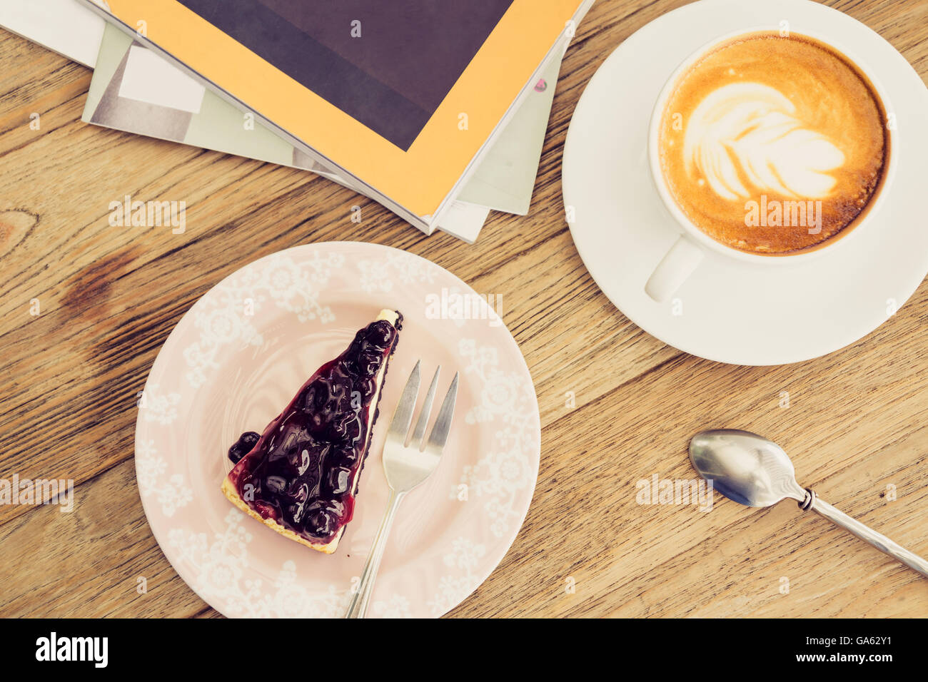 Hot coffee latte with blue berry cheese cake leisure lifestyle on wooden table Stock Photo