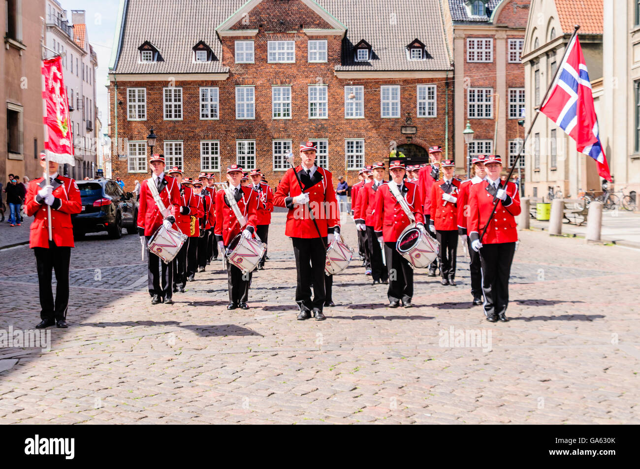 Marching band carrying a Danish Flag perform in Copenhagen Stock Photo