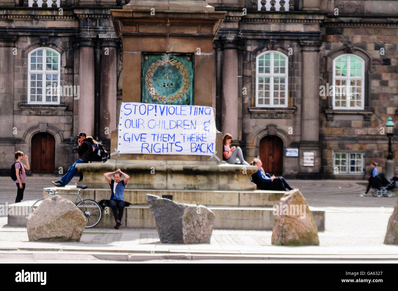 Protest banner in Copenhagen 'Stop! Violetiing our children & give them theire rights back!' [sic] Stock Photo