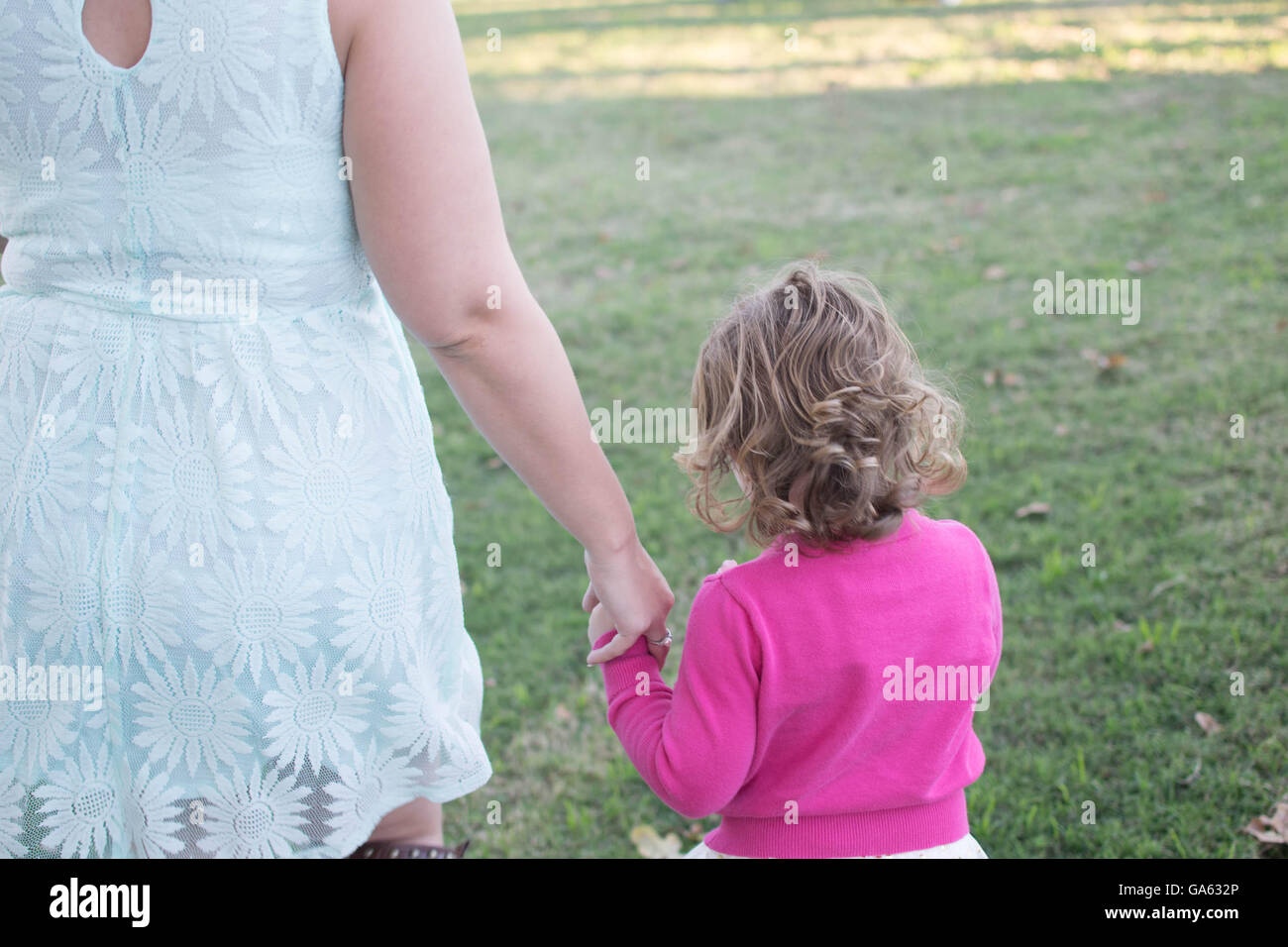 Mom and Daughter holding hands Stock Photo