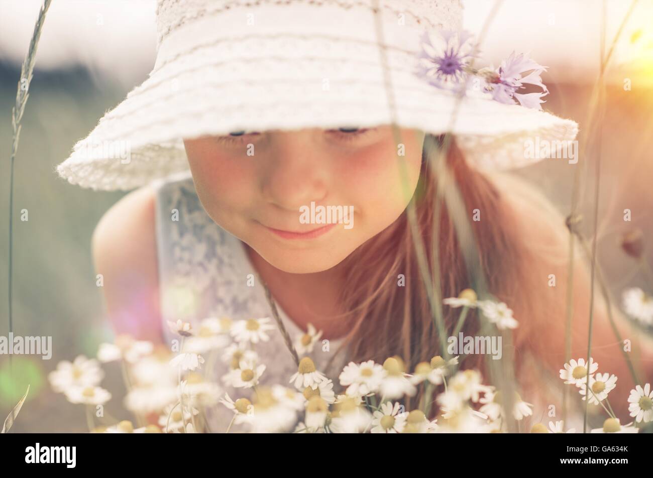 Caucasian Girl Exploring the Nature. Journey Into the Summer Meadow. Stock Photo