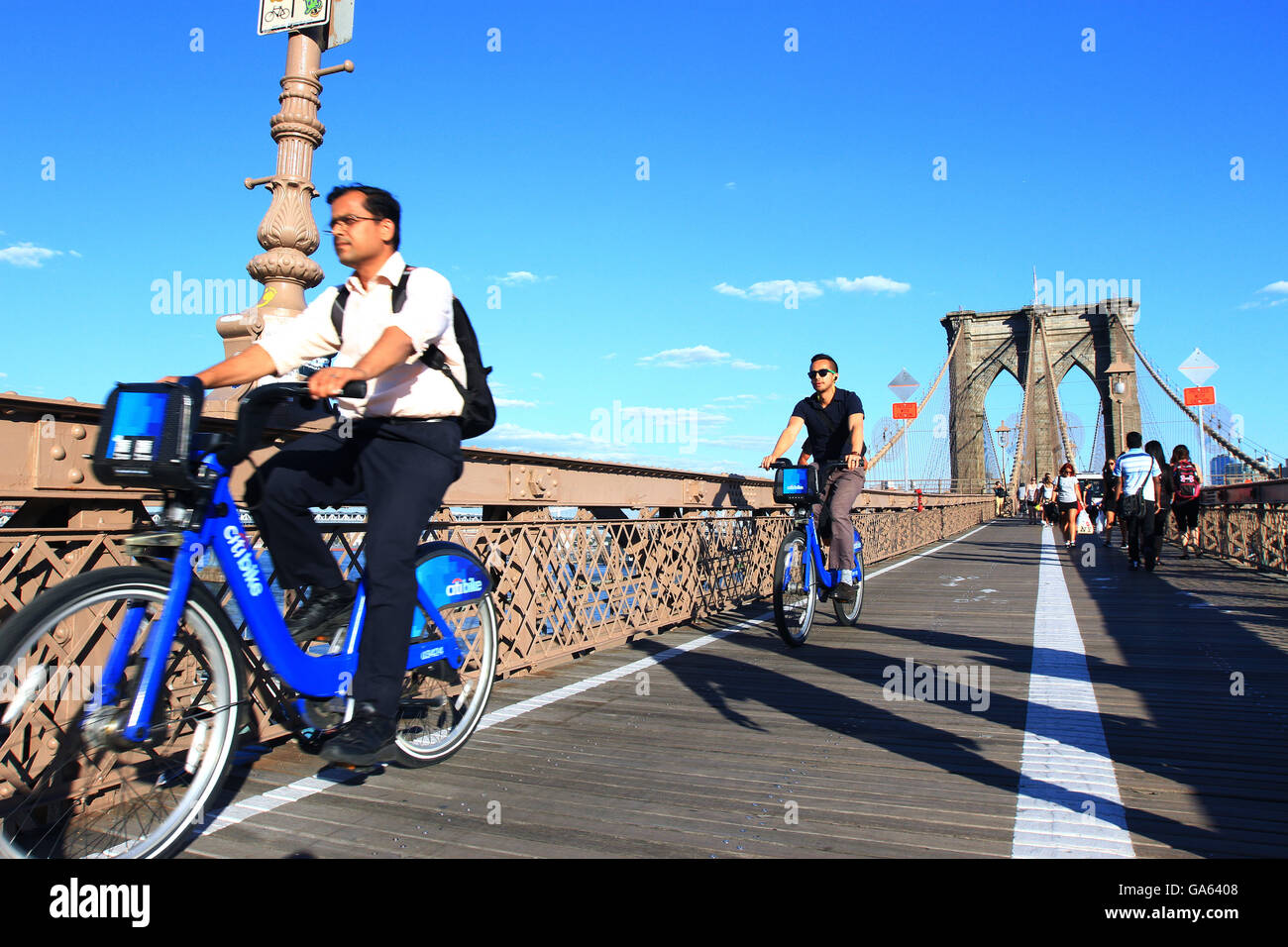 Tourists travel across Brooklyn Bridge in New York on Citibike