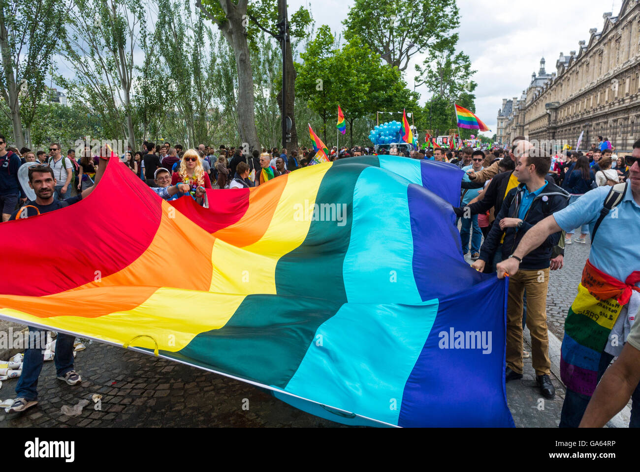 Paris, France, Crowd People Holding Gay Rainbow Flag at Gay Pride, LGBTQ Activism, Marching on Street, Campaign for Homosexual Equality, gay rights activists protesting Stock Photo