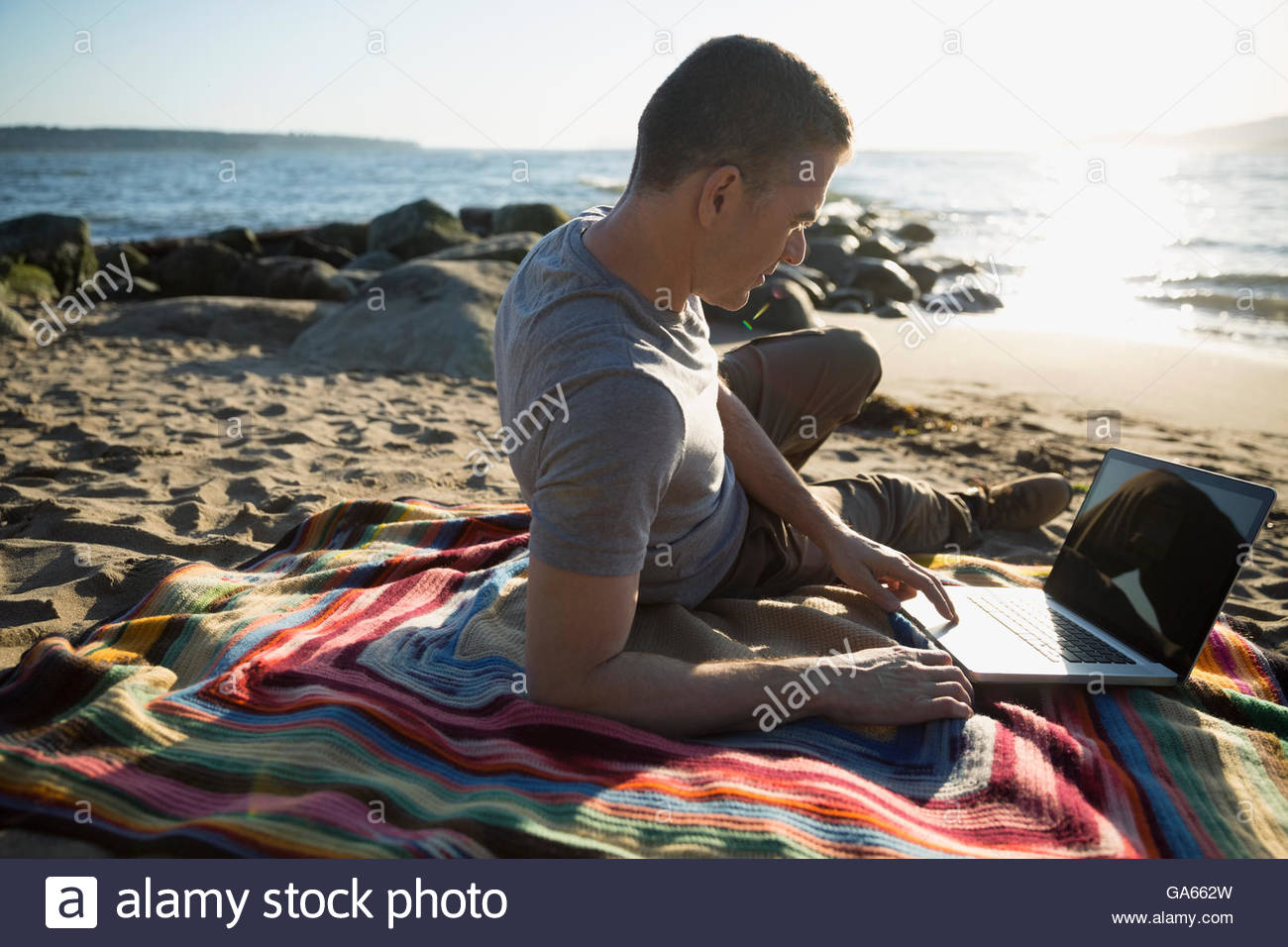 Man on laptop beach hi-res stock photography and images - Alamy