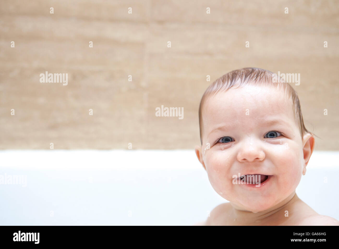 9 months baby boy having fun in the bathtub Stock Photo