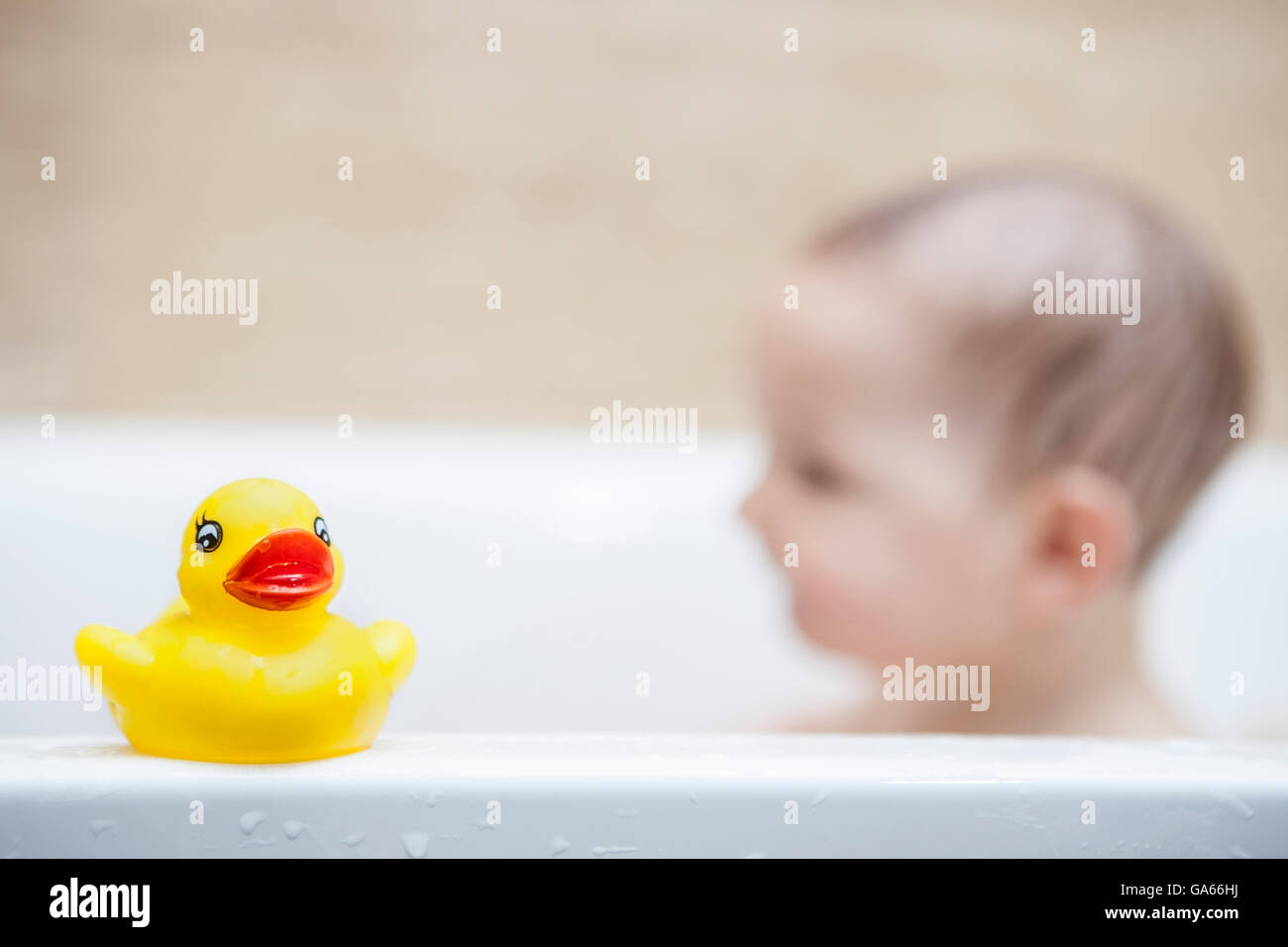 9 months baby boy having fun in the bathtub Stock Photo