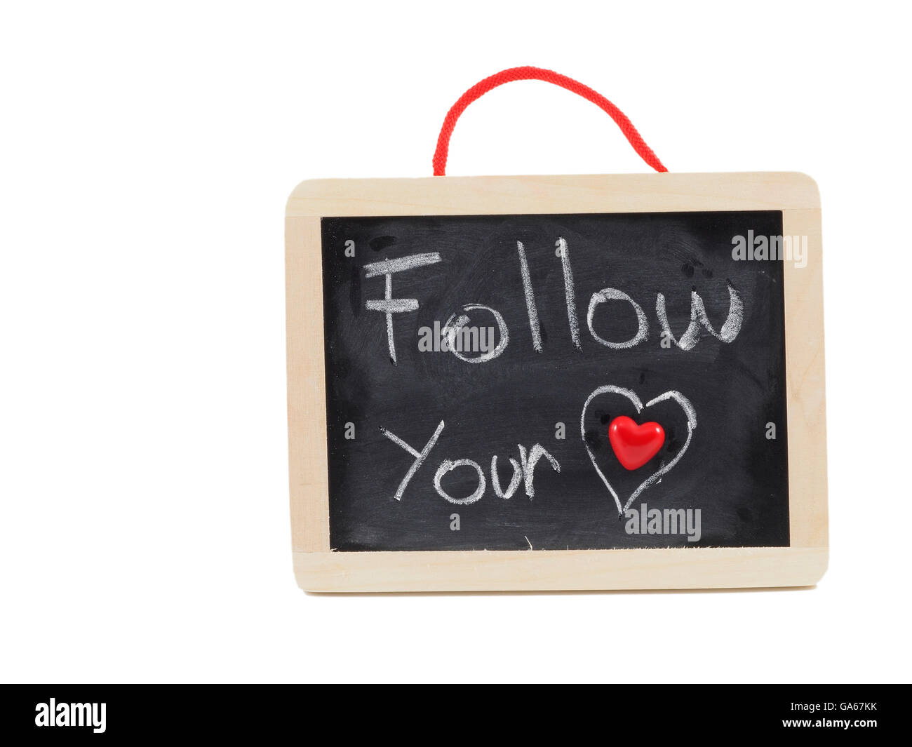 'Follow your heart' written on a wooden chalkboard using white chalk and a red tiny heart. Stock Photo
