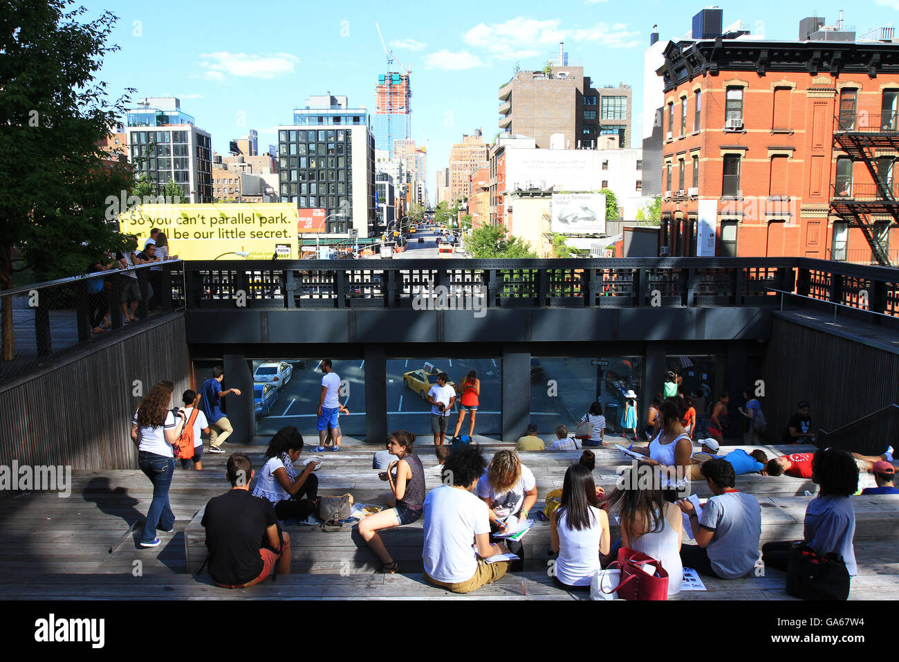 People tour and enjoy the High Line public park in New York City during ...