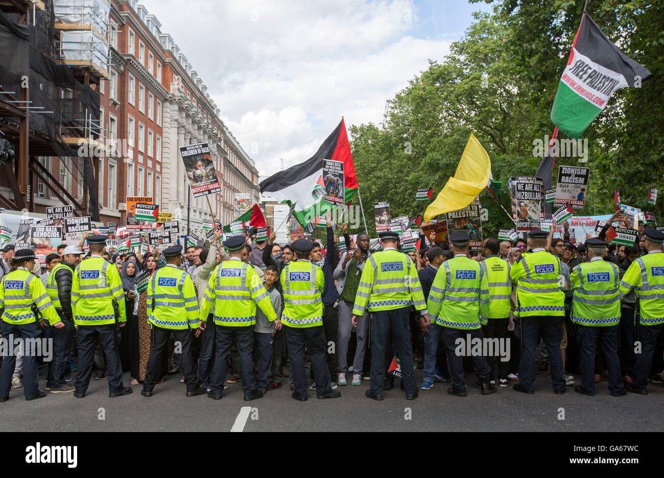Police contain pro-Palestinian supporters as they take part in a rally in central London, to commemorate Al-Quds Day, a day that has been marked globally since being inaugurated in 1979 by Ayatollah Khomeini who asked for the last Friday in the Islamic holy month of Ramadan to be set aside as a day for uniting against Israel and showing support for Palestinians. Stock Photo