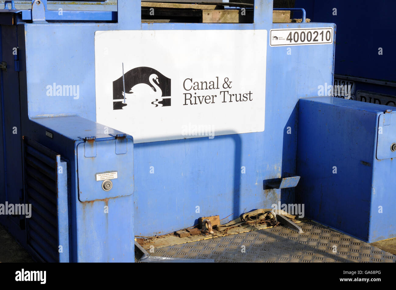 Maintenance vessel bearing Canal & River Trust branding on the Grand Union Canal near Long Itchington, Warwickshire, England Stock Photo
