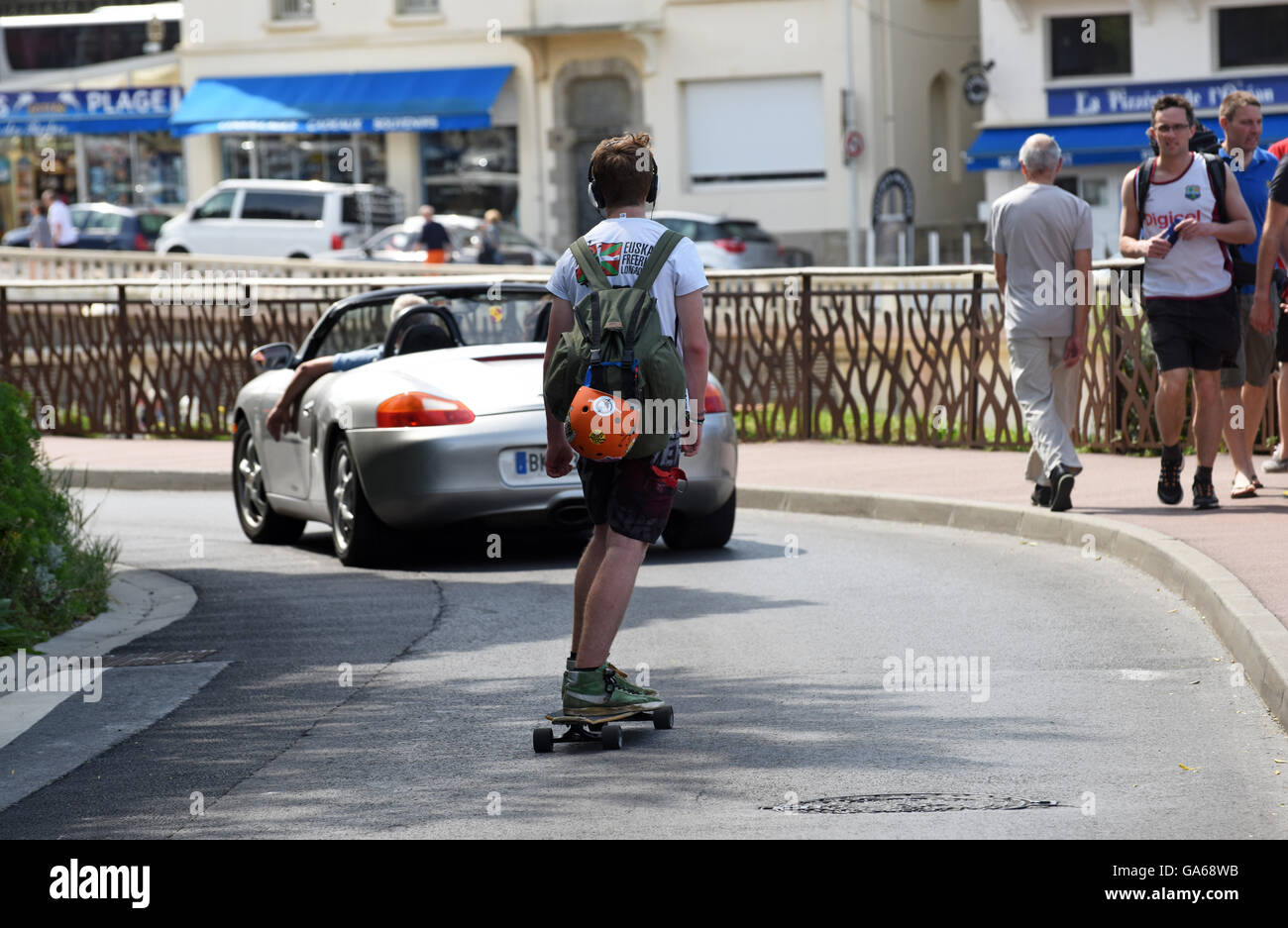 Man boy skate boarding on road Stock Photo