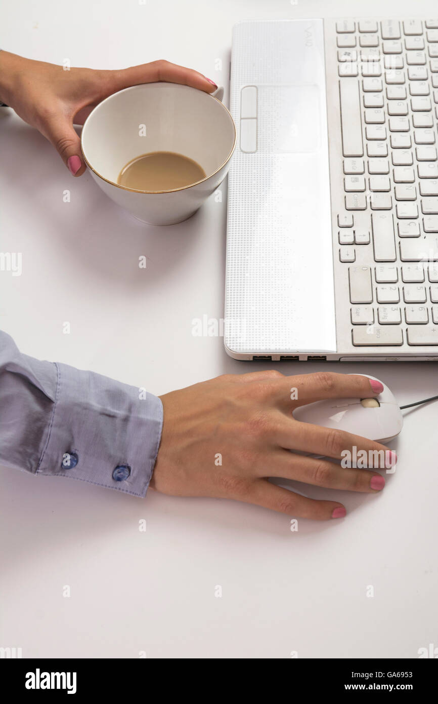 Female hands typing on keyboard,  in a white computer Stock Photo