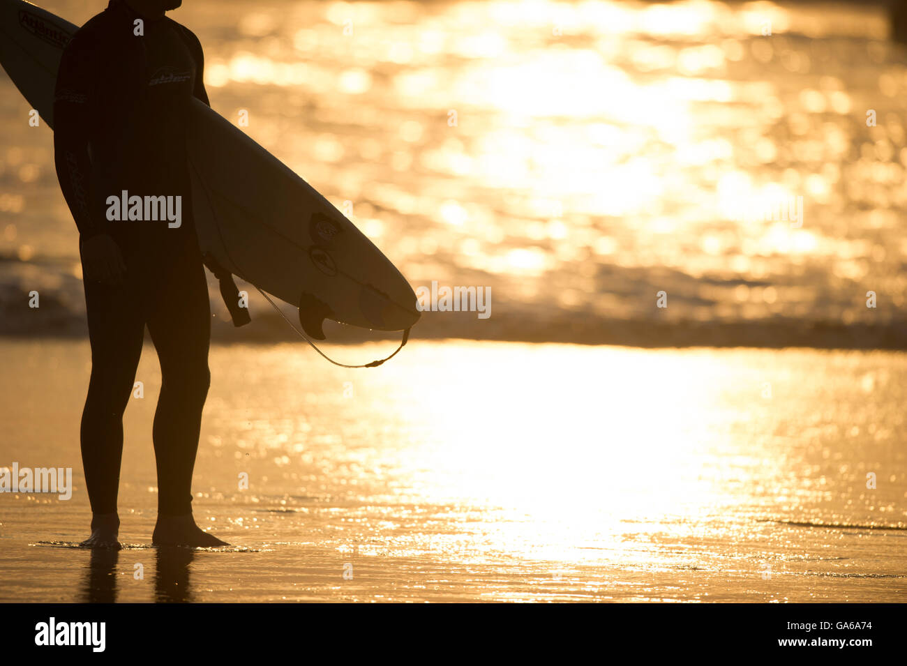 surfer in silhouette at sunset Stock Photo - Alamy
