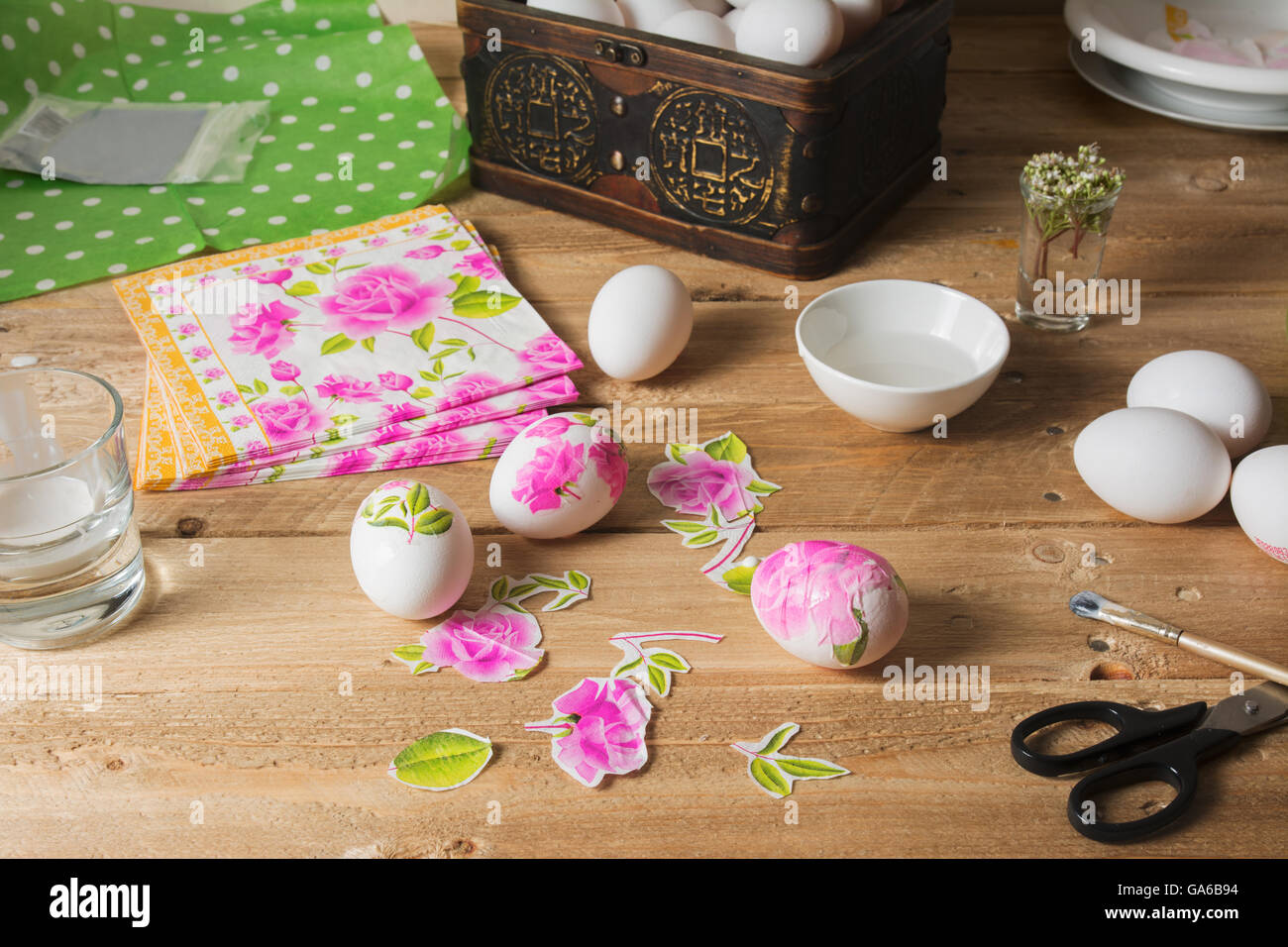 Apply woman PVA glue on colored Easter egg, with the technique of