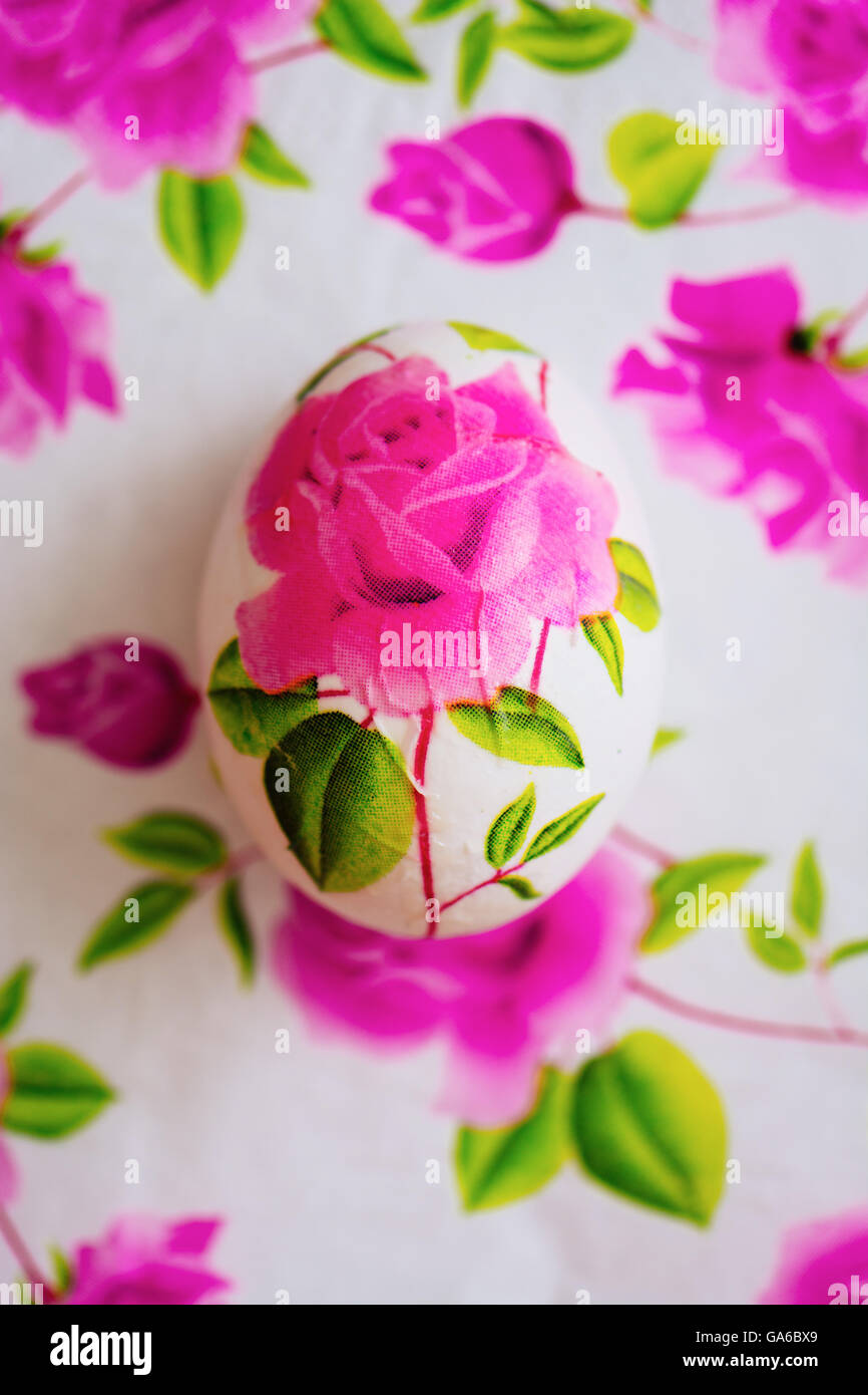 Decoupage Easter egg, Decorated with flowered paper napkins and stuck with glue, above view