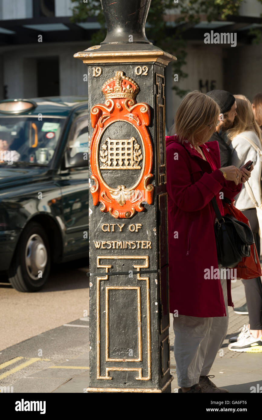 London, England, UK - September  25, 2015: Decorative street lamp base with the crest of the City of Westminster Stock Photo