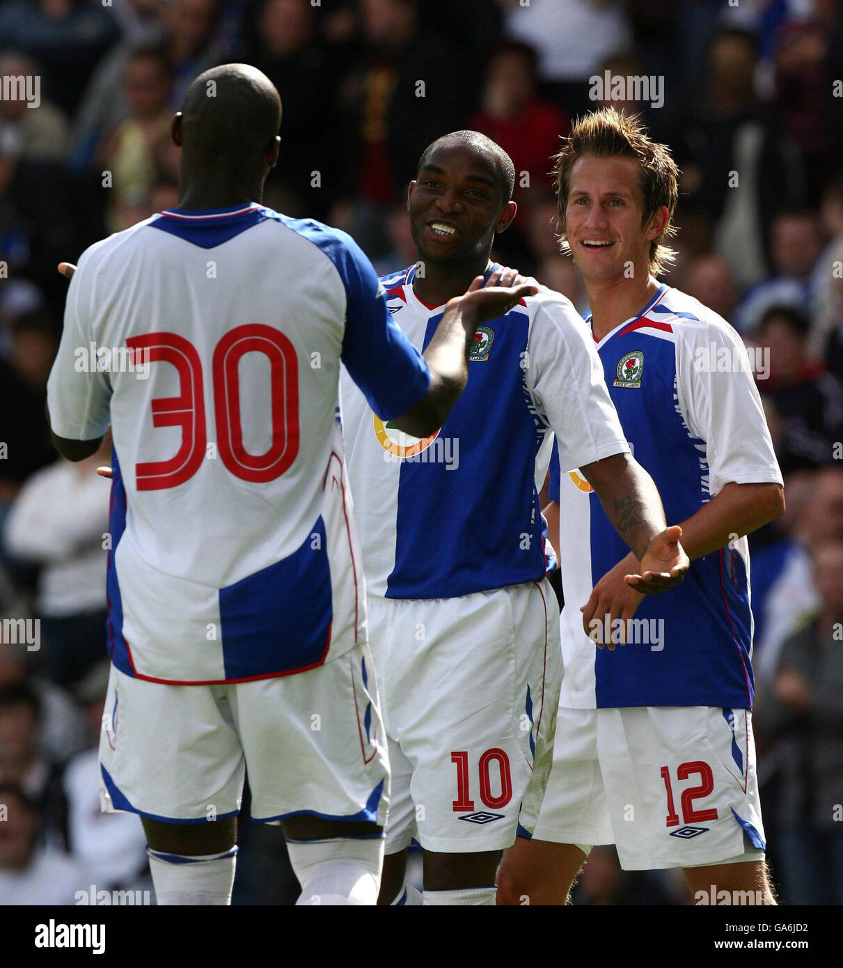 Blackburn Rovers' Benni McCarthy (centre) celebrates his goal with fellow goalscorers Morten Gamst Pedersen (right) and Jason Roberts (left) during the Intertoto Cup third round second leg match at Ewood Park, Blackburn. Stock Photo