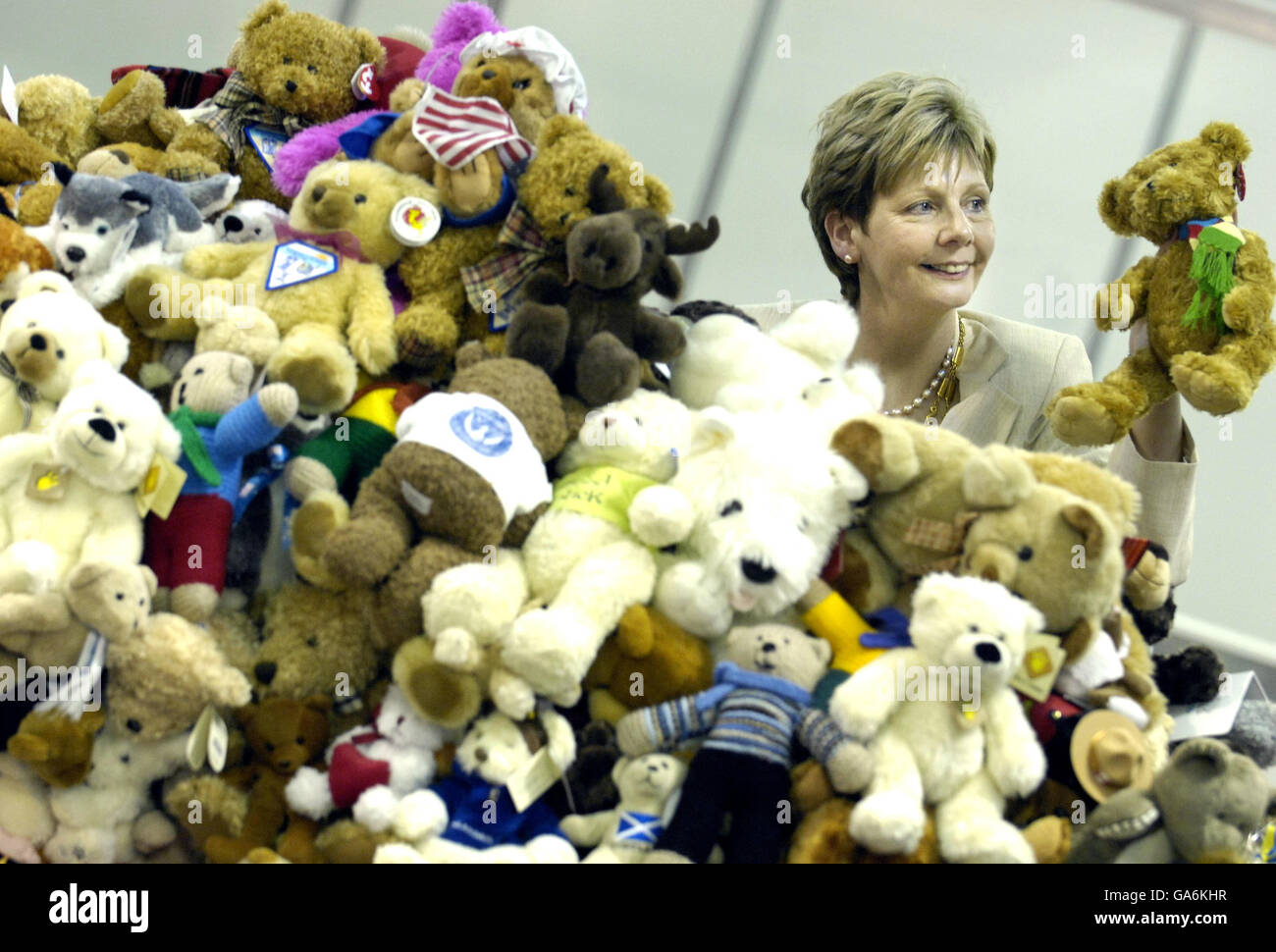 Soroptimist International President Lynn Dunning with a giant mountain of 2,000 teddy bears at the SECC in Glasgow. Stock Photo