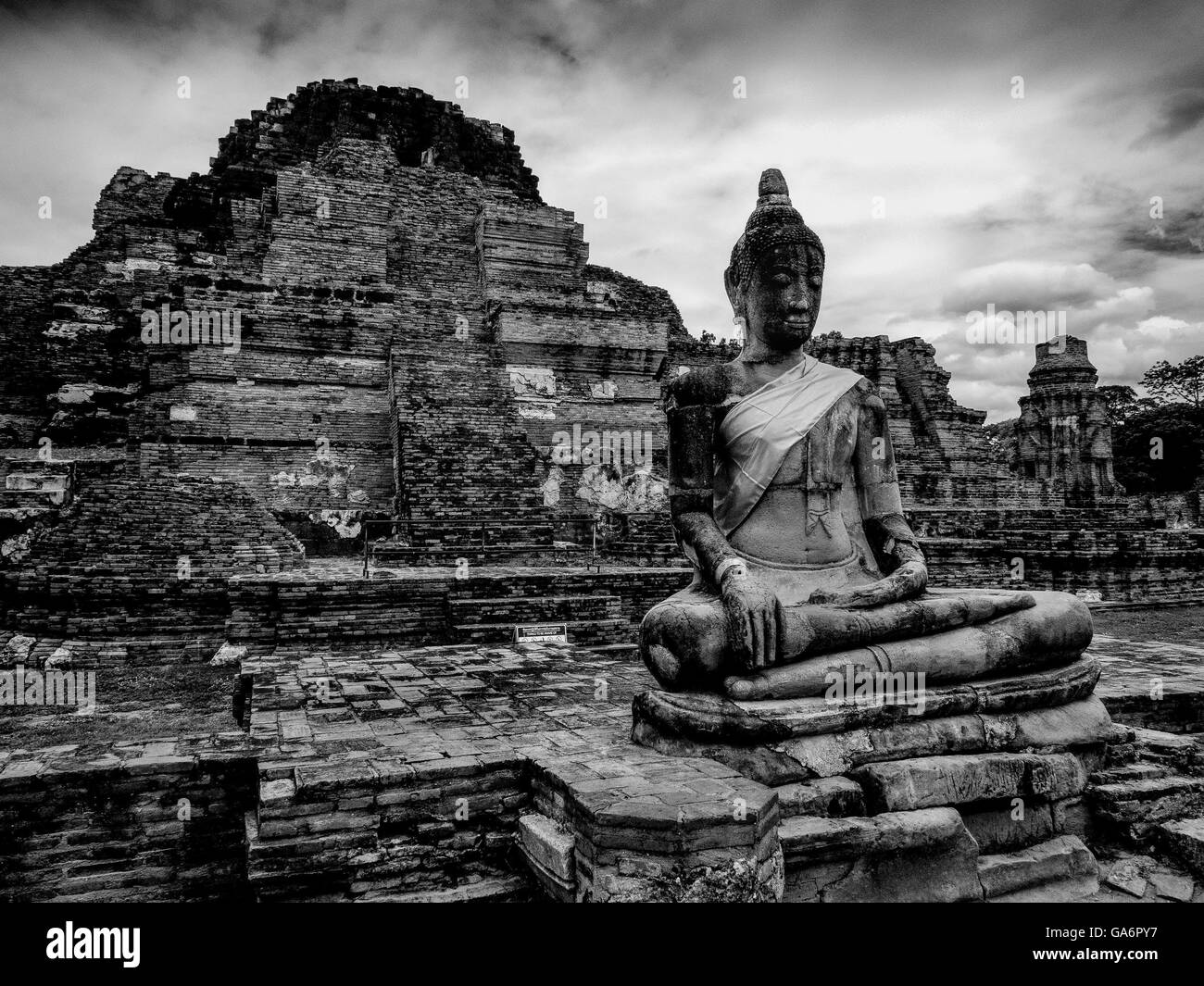 Wat Mahathat Temple Buddha statue amongst ruins in Ayutthaya Thailand Stock Photo