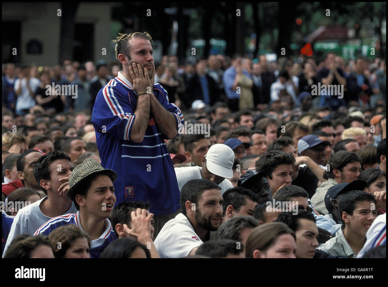 Crowd of fans watch French soccer team game on giant screen in Paris, France, June 2002. Stock Photo