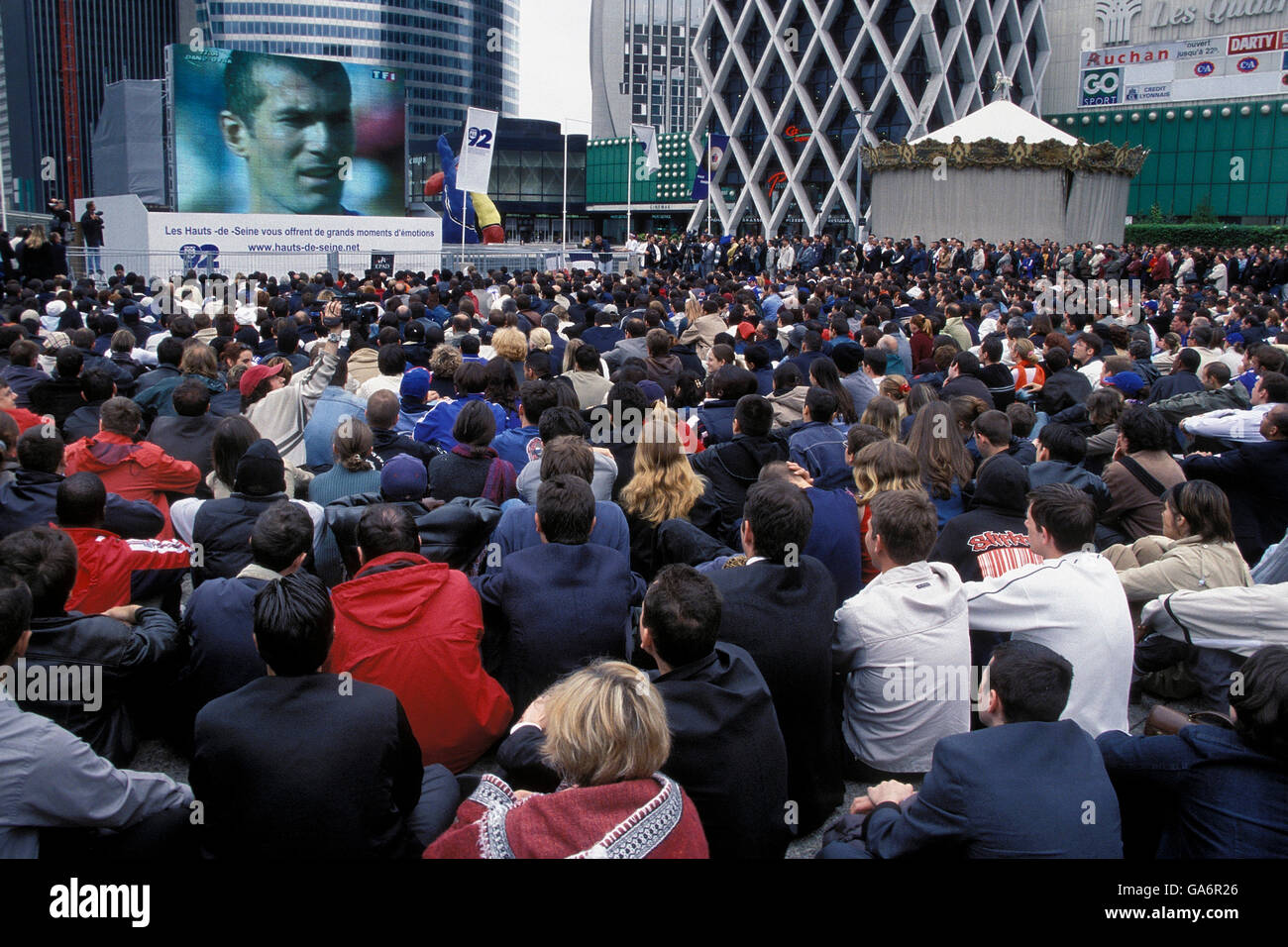 The face of star French soccer star Zinedine Zidane appears on a giant screen during a public World Cup viewing at La Defense, France, June 2002. Stock Photo
