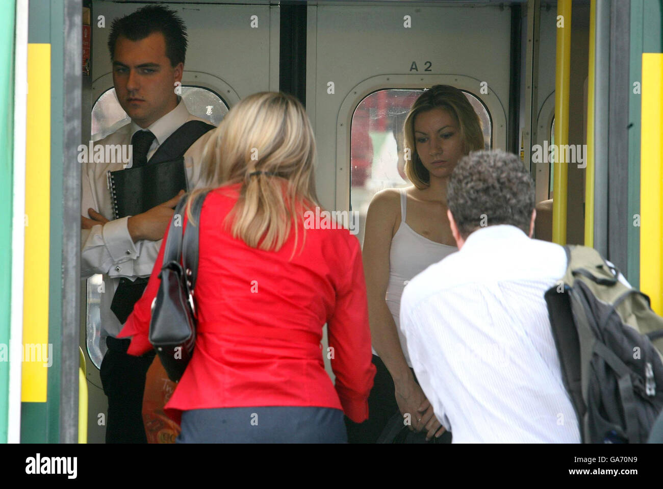 Commuter train stock. Commuters board a train at Clapham Junction in south-west London, bound for Victoria Station. Stock Photo