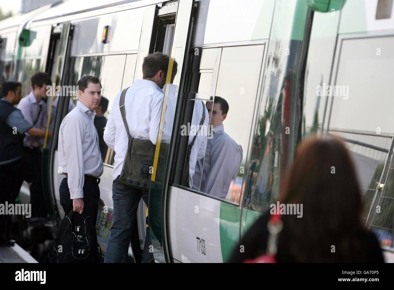 Commuter train stock. Commuters board a train at Clapham Junction in south-west London, bound for Victoria Station. Stock Photo