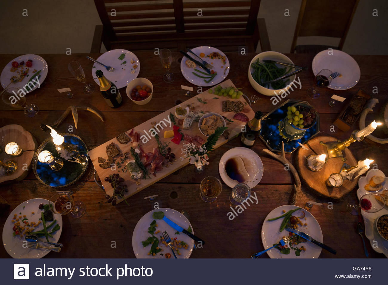 Candles illuminating food on dining table at night Stock Photo Alamy