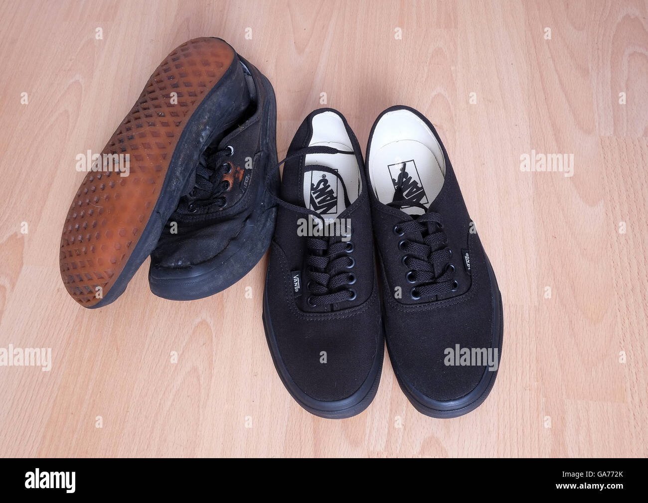 New and old black sneakers or trainers used by a waitress in a