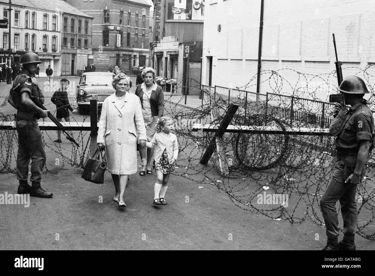 People move to and from the Bogside area of Londonderry after a night of rioting in which at least five people were shot dead. Stock Photo