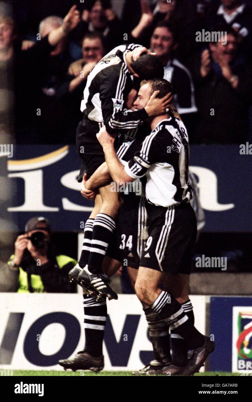 Newcastle United's Kieron Dyer is carried by Nikos Dabizas and Alan Shearer while celebrating scoring the second goal against Leeds United Stock Photo